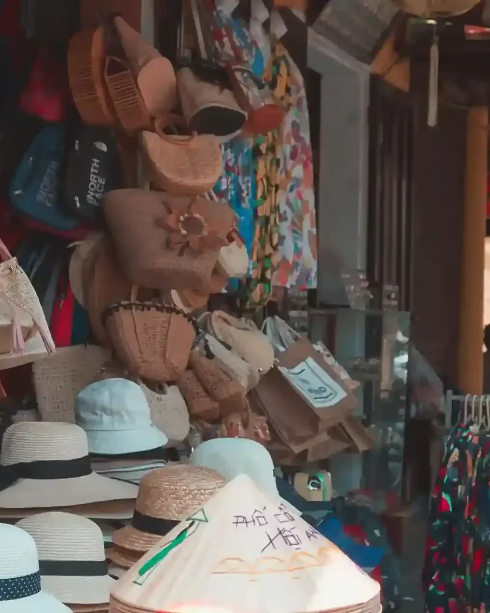 Woven bags and hats on display at a Bali market