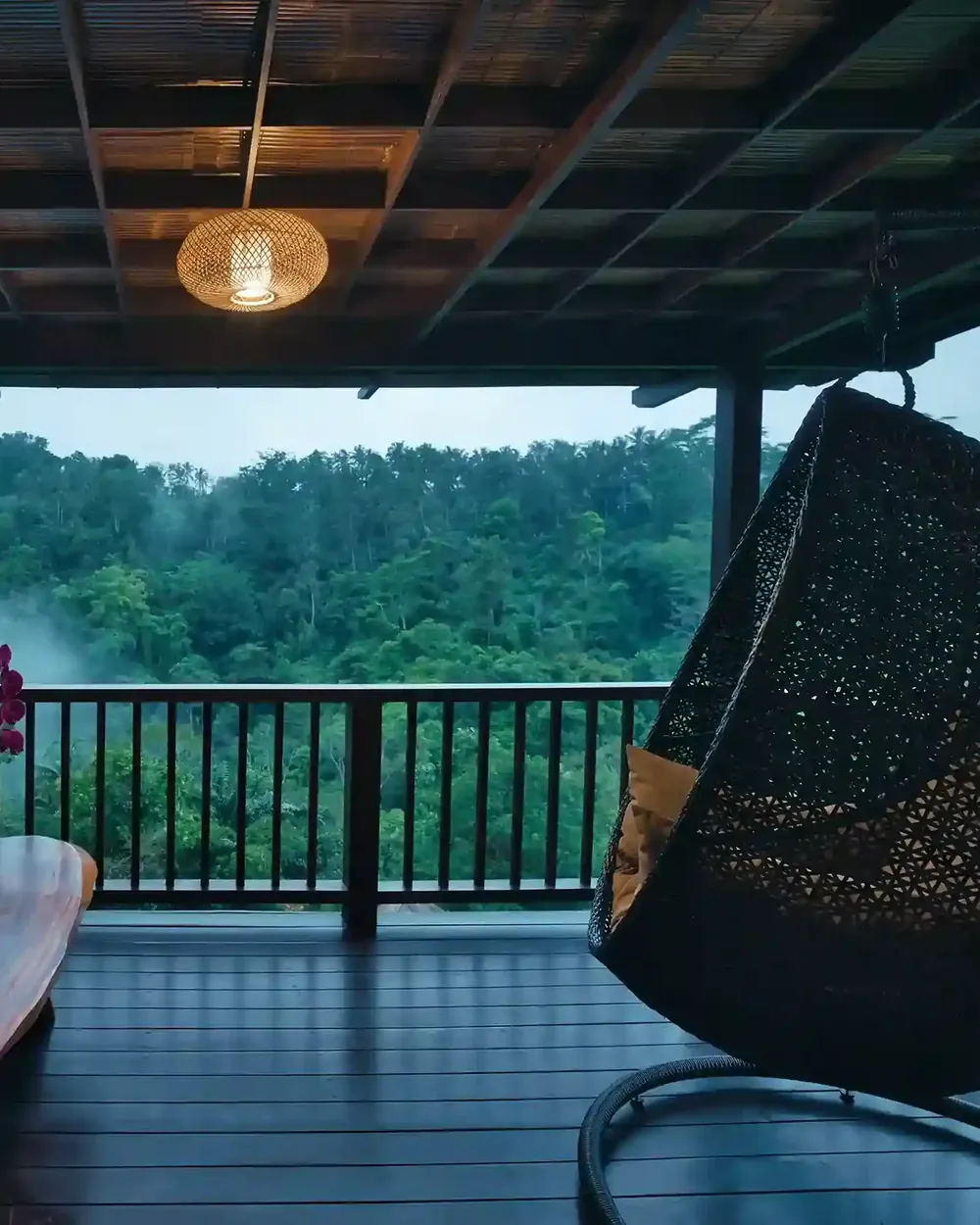 Hanging woven chair on a jungle balcony