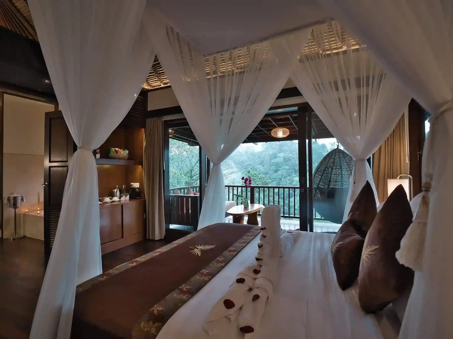 Resort room with a canopy bed and woven ceiling