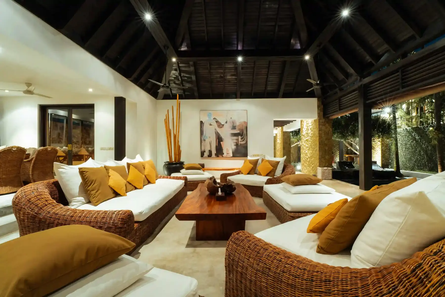 Villa lounge furnished with woven rattan armchairs
