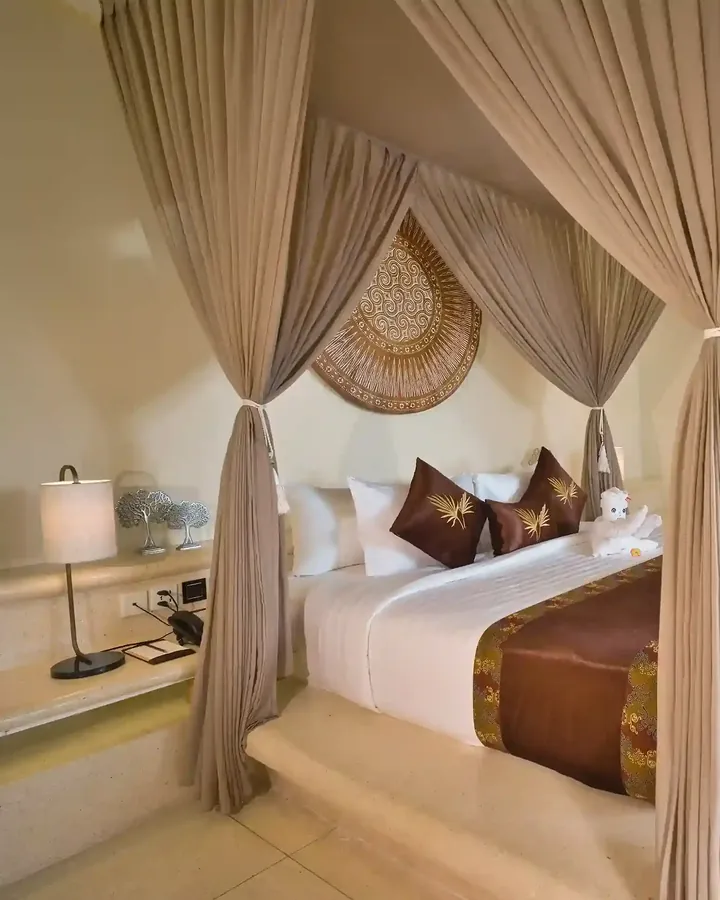 Round woven wall piece above a bed in a Bali villa